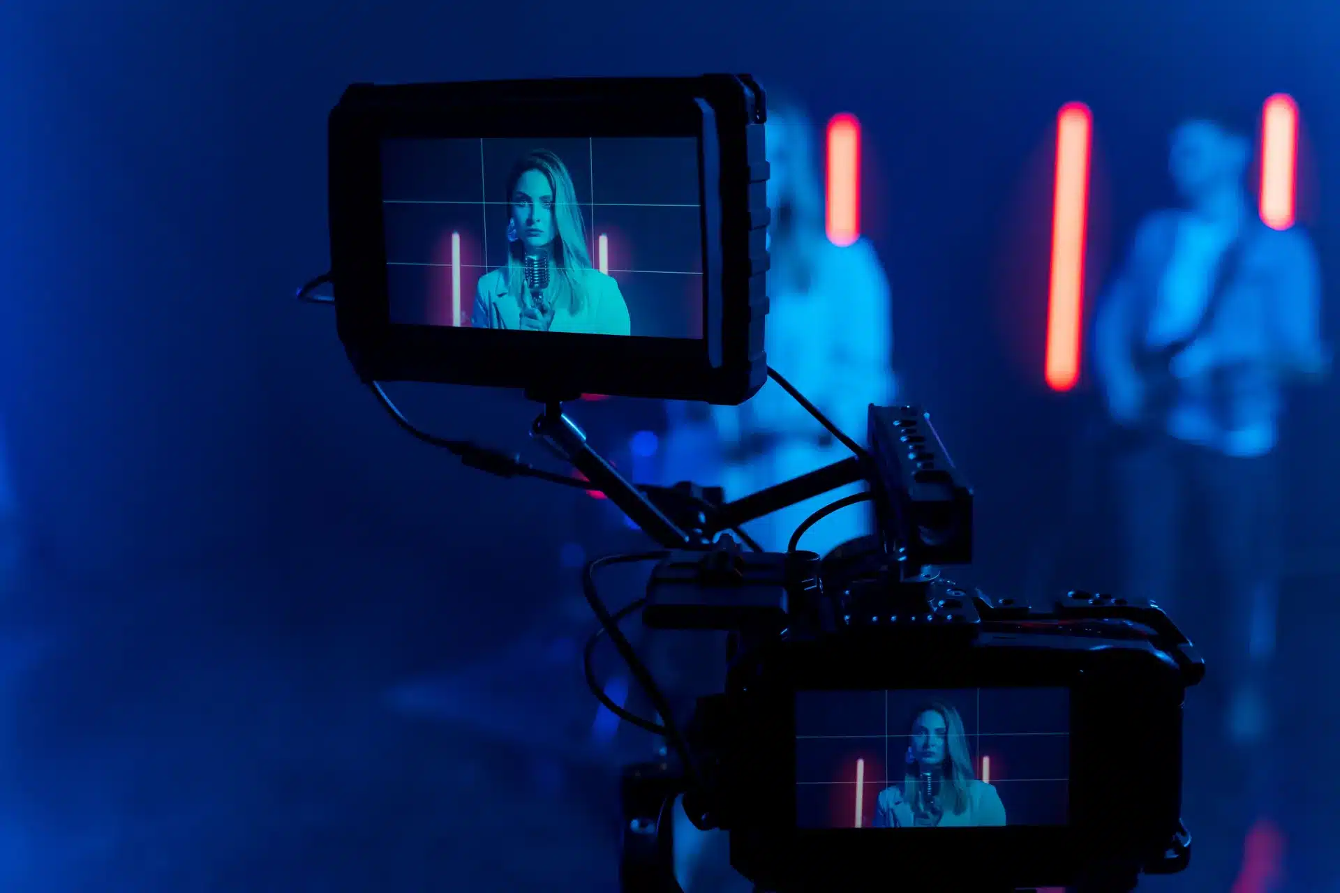 Professional video production camera monitor showing subject on screen during a marketing video shoot